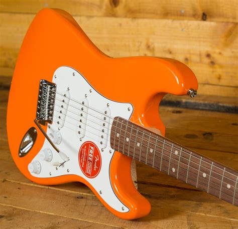 Squier Affinity Stratocaster electric guitar in bright competition orange finish with white pickguard and maple neck, displayed upright against a plain background