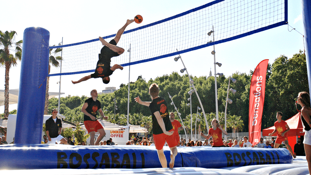 Players jumping on trampolines while playing Bossaball, an unusual sport that mixes volleyball, soccer, and gymnastics.