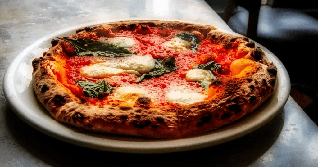 Classic Italian Pizza Margherita with fresh tomatoes, mozzarella, and basil showcases why Italy is among the countries with the best cuisines.