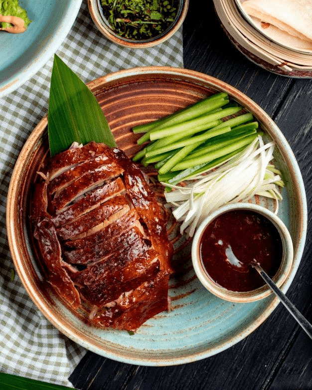 Crispy Chinese Peking Duck served with pancakes and hoisin sauce, proving China’s place among the countries with the best meal.
