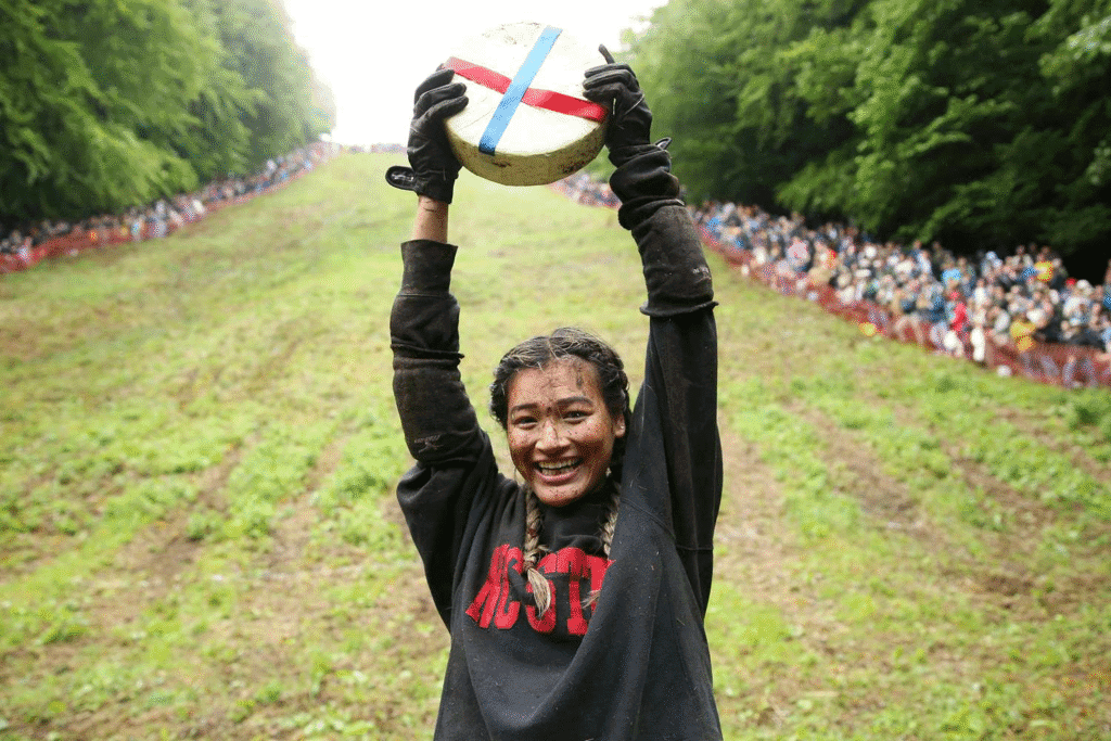 Dangerous but fun cheese-rolling race with people sliding and tumbling on a steep hill. bizarre festivals in the world